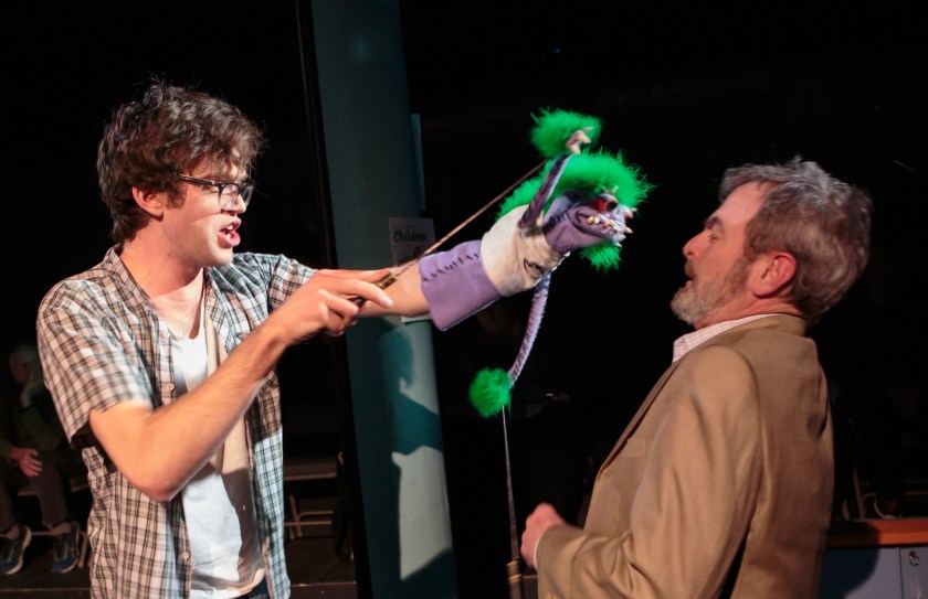 Jason (Danny Turek), a teenager possessed by his demonic hand puppet, threatens Pastor Greg (Jonathan Putnam) in Short North Stage’s production of Hand to God. (Photo by Jason Allen)